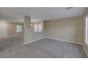 Neutral living room features a carpeted floor and large windows for lots of natural light at 141 Fox Lake Ave, Las Vegas, NV 89148