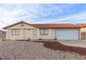 Single-story home with a tile roof, neutral stucco and a spacious two-car garage at 1892 Maricopa Dr, Laughlin, NV 89029