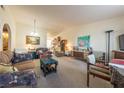 Inviting living room featuring bright lighting, carpeted floors and comfortable seating at 1892 Maricopa Dr, Laughlin, NV 89029