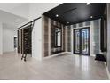 Grand foyer featuring high ceilings, unique wall decor and double doors to the exterior at 20 Pebble Hills Ct, Las Vegas, NV 89141