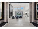 Stunning foyer with tall ceilings, gorgeous chandeliers, and sleek tile flooring at 20 Pebble Hills Ct, Las Vegas, NV 89141