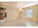 Neutral dining room with tile flooring, chandelier lighting and plantation shutters at 2186 Savannah River St, Henderson, NV 89044