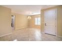 Spacious living room with tile flooring, neutral paint and chandelier lighting at 2186 Savannah River St, Henderson, NV 89044