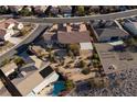 An aerial view displaying a home with desert landscaping, a covered patio, and surrounding neighborhood at 2401 Orangeburg Pl, Henderson, NV 89044