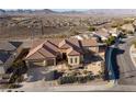 Inviting single-story home with desert landscaping in front, paired with attached two-car garage at 2401 Orangeburg Pl, Henderson, NV 89044