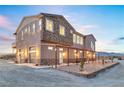 Beautiful home featuring stone accents and a pergola-covered front patio with desert landscaping at 2590 Luke St, Pahrump, NV 89060