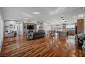 Open concept living room featuring hardwood floors, a fireplace, and a large kitchen at 2590 Luke St, Pahrump, NV 89060