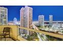 Balcony with chairs offering skyline views of the high rise buildings and busy Las Vegas streets at 2857 Paradise Rd # 2103, Las Vegas, NV 89109