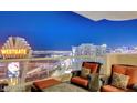 Wide angle view of a balcony with orange patio seating that overlooks the Las Vegas cityscape at 2857 Paradise Rd # 2103, Las Vegas, NV 89109