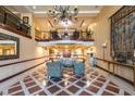 Grand lobby area with high ceilings, elegant chandelier, and comfortable seating, creating a welcoming atmosphere at 30 Strada Di Villaggio # 521, Henderson, NV 89011