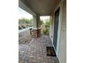 Inviting front porch area with a brick pathway, decorative plants, and a welcoming 'Home' doormat at 3160 Del Dotto Walk, Henderson, NV 89044