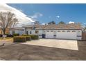 Beautiful single-story home showcasing a three-car garage and well-maintained landscaping at 320 Cimmarron Pl, Pahrump, NV 89048