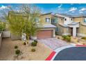 Beautiful two-story home featuring a brick driveway, desert landscaping, and a modern architectural design at 340 Largo Vista Ct, North Las Vegas, NV 89084