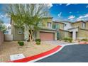 Charming home with desert landscaping, brick driveway and a two-car garage at 340 Largo Vista Ct, North Las Vegas, NV 89084