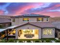 Beautiful home exterior featuring a covered patio, solar panels, and mountain views at sunset at 3929 Reyes Ave, Las Vegas, NV 89141