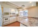 Bright kitchen featuring white cabinets, tile backsplash, and ample counter space at 3963 Redwood St, Las Vegas, NV 89103