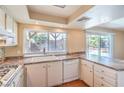 Well-lit kitchen with white cabinets, stone countertops, and backyard pool views at 3963 Redwood St, Las Vegas, NV 89103