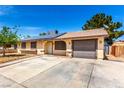 Inviting single-story home with solar panels, a landscaped front yard, and attached garage at 4360 Wendy Ln, Las Vegas, NV 89115