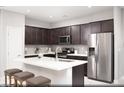 Modern kitchen with stainless steel appliances, a large island, and dark wood cabinets at 470 Ylang Pl # Lot 9, Henderson, NV 89015