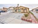 Single story home with desert landscaping and a spacious driveway at 5166 Silverheart Ave, Las Vegas, NV 89142