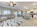 Bright, open-concept living room with modern rug, seamlessly connected to kitchen at 5236 Sunstone Mesa Dr, Las Vegas, NV 89166
