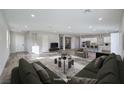 Spacious living room featuring neutral walls, plush sofa, and seamless flow into the kitchen at 5846 Slate Rock Ct, Las Vegas, NV 89149