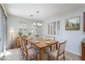 Cozy dining room with natural light, chandelier, and seating for six at 609 Viale Machiavelli Ln, Henderson, NV 89011