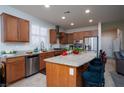 Spacious kitchen features granite counters, stainless appliances, and breakfast bar at 609 Viale Machiavelli Ln, Henderson, NV 89011