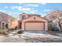 Charming two-story home with a neutral color scheme, featuring a two-car garage and landscaping at 6697 Boom Town Dr, Las Vegas, NV 89122