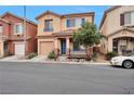 Inviting two-story home featuring a covered porch, desert landscaping, and a private driveway at 6891 Nickel Mine Ave, Las Vegas, NV 89122