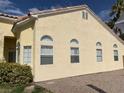 Side view of a tan single story home showing many windows at 7456 Oatman Ln, Las Vegas, NV 89120