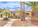 Charming single-story home surrounded by desert landscaping, featuring a tiled roof and a welcoming front entrance at 7613 Falconwing Ave, Las Vegas, NV 89131