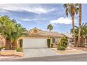 Attractive single-story house features desert landscaping, a two-car garage, and mature palm trees in the front yard at 7613 Falconwing Ave, Las Vegas, NV 89131