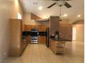 Spacious kitchen with wooden cabinets, stainless steel appliances, and an island at 7613 Falconwing Ave, Las Vegas, NV 89131