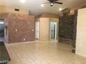 Open living area with tile flooring, stone accent wall, and recessed lighting at 7613 Falconwing Ave, Las Vegas, NV 89131