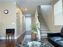 Inviting entryway with hardwood floors, a staircase, and a view of the front door at 7735 Pista Way, Las Vegas, NV 89179