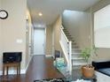 Inviting entryway with hardwood floors, a staircase, and a view of the front door at 7735 Pista Way, Las Vegas, NV 89179