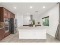 Modern kitchen boasting stainless steel appliances, a large island, and sleek countertops at 780 Flowing Meadow Dr, Henderson, NV 89014