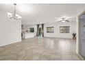 Bright living area with tile flooring, modern lighting fixtures, and direct access to the backyard through sliding doors at 780 Flowing Meadow Dr, Henderson, NV 89014