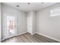 Bright room with wood-look floors, a door to the outside, and a closet at 8629 Ensworth St # 112, Las Vegas, NV 89123