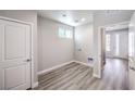 Spacious laundry room with light wood-look floors and white walls, featuring a door and window at 8629 Ensworth St # 113, Las Vegas, NV 89123