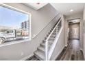 Bright staircase with carpeted steps, light gray walls, and modern railing at 8629 Ensworth St # 114, Las Vegas, NV 89123