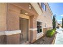 Covered entryway with visible unit number, stucco columns, and manicured landscape at 8798 Tom Noon Ave # 103, Las Vegas, NV 89178