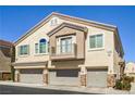 Well-kept townhome featuring a three-car garage, second story balcony, and stucco facade at 8798 Tom Noon Ave # 103, Las Vegas, NV 89178