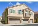 Attractive townhome showcasing a three-car garage, and a charming, covered balcony at 8798 Tom Noon Ave # 103, Las Vegas, NV 89178