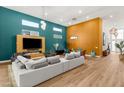 Bright living room with modern furniture, fireplace, and large windows providing ample natural light at 10794 White Clay Dr, Las Vegas, NV 89135