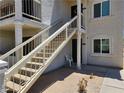 Condo exterior featuring stairs to the second floor, showing the building's entrance and facade at 1904 Las Palmas Ln # 101, Laughlin, NV 89029