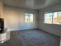 Inviting living room with neutral carpet, bright windows, and a cozy fireplace on a sunny day at 1904 Las Palmas Ln # 101, Laughlin, NV 89029