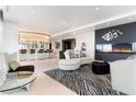 Open-concept living area featuring a fireplace, bar, and zebra print rug at 200 W Sahara Ave # 4101, Las Vegas, NV 89102