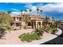 Stunning exterior of the home showcasing its desert landscaping, stone accents, and inviting entrance at 2540 Red Arrow Dr, Las Vegas, NV 89135